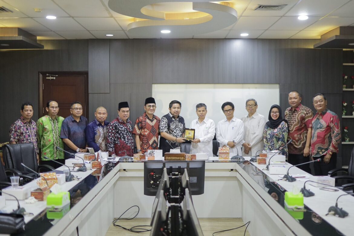 Wakil Ketua DPRD Provinsi Kalsel Muhammad Syaripuddin menyerahkan plakat dewan usai sharing koordinasi dan sinkronisasi untuk perjuangkan aspirasi guru madrasah ke Ditjen Pendis Kemenag RI di Jakarta.(foto : humasdprdkalsel)