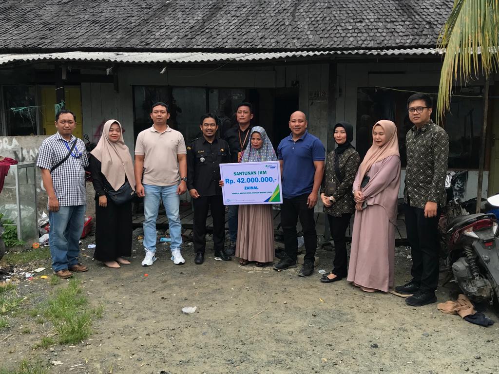 SANTUN JKM-BPJS Ketenagakerjaan Batulicin saat menyerahkan santunan JKM di kediaman almarhum Zainal di Desa Bersujud bersama Direktur PT JML Efgar Welmar Santos dan Kepala Desa Bersujud Jumriadi, Kamis (2/11/2023).(foto : ist)