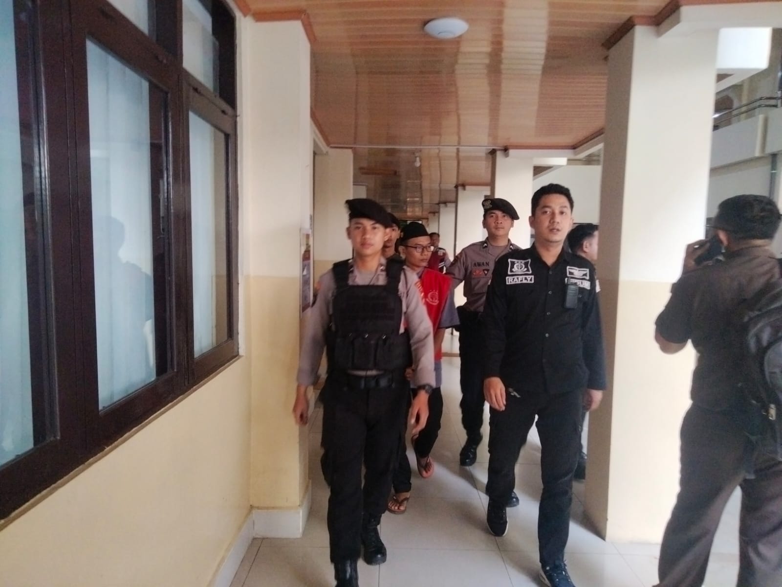 Terdakwa Maulani saat dikawal aparat menuju ruang sidang garuda PN Banjarmasin. (Foto: Filarianti)