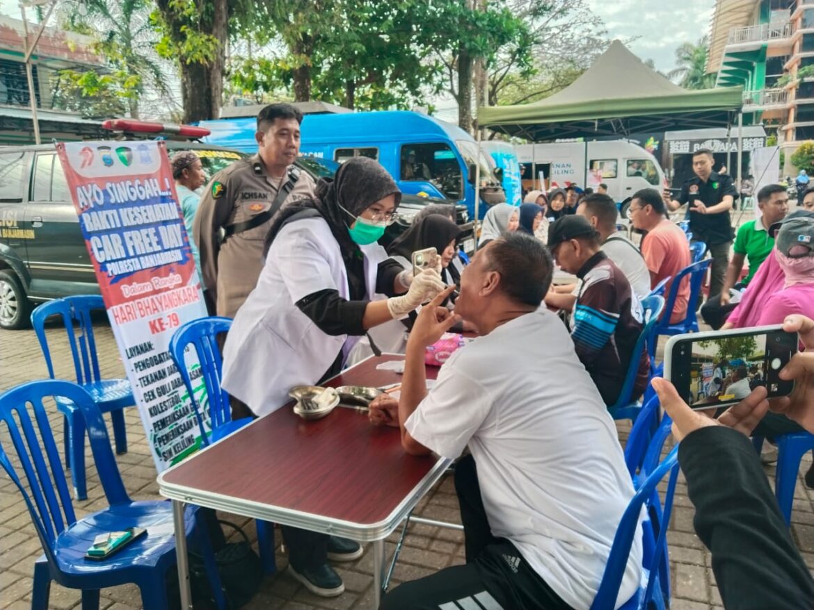 Kabag Ops Polresta Banjarmasin Kompol I Made Subagya saat diperiksa oleh dokter gigi dalam Bhakti Kesehatan Polresta Banjarmasin di Siring Menara Pandang, Minggu (22/6/2025) pagi. (foto:sum/brt).