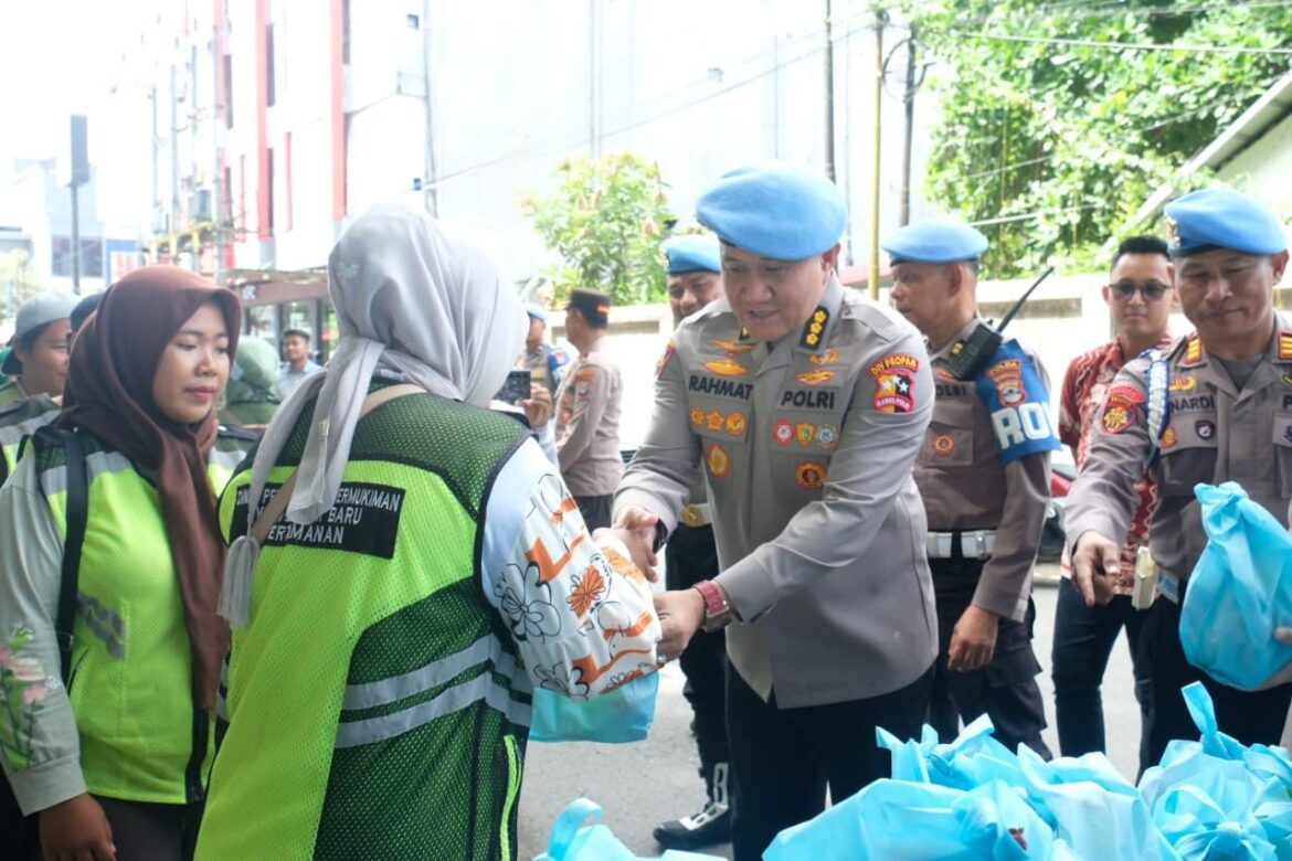 Petugas Propam Polda Kalsel mengenakan baret biru saat membagikan bingkisan Jumat Berkah kepada pengemudi ojol dan petugas kebersihan di Jalan Pangeran Hidayatullah, Banjarbaru (Foto: Iman Satria)